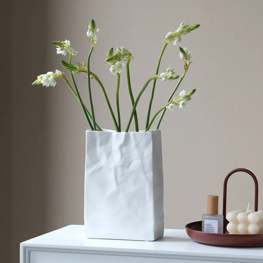 Minimalist ceramic flower vase with fresh flowers, perfect for home decor by Gizmo Gadgets