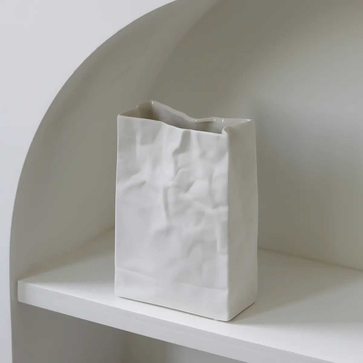 Stylish white ceramic flower vase with a modern crumpled design for home decor