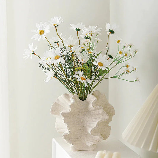 Elegant European ceramic vase with a unique ruffled design, featuring white daisies arranged inside