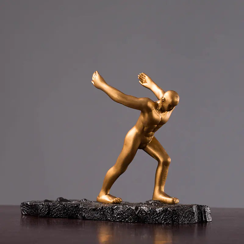 Contemporary golden sculpture of a dancing figure on a dark base, ideal for display with a decorative wine rack for cabinet