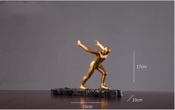 Golden decorative sculpture on black base, ideal as a decorative wine rack for cabinet