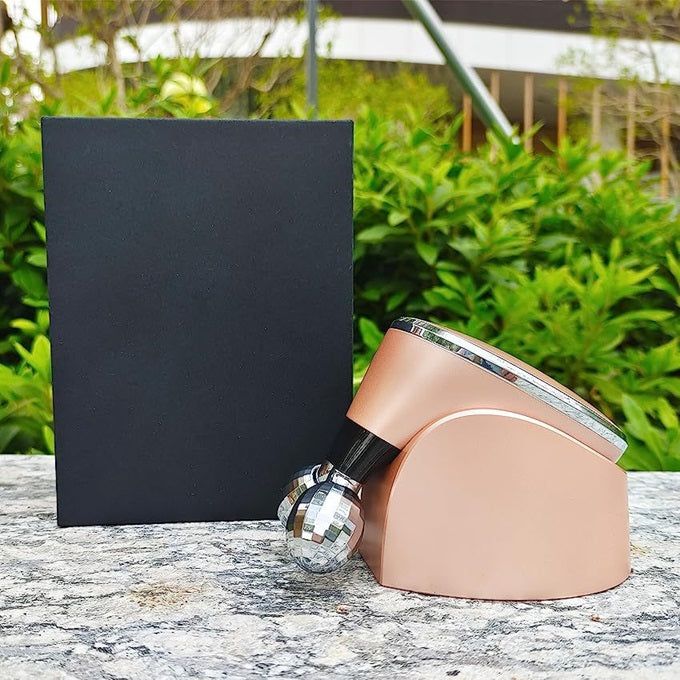 Gizmo Gadgets electric facial massage roller in rose gold design for rejuvenating skin care