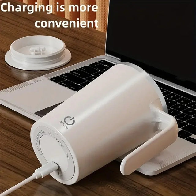 Gizmo Gadgets Magnetic coffee mug with handle charging on a desk next to a laptop