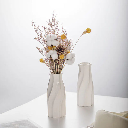Minimalist white vase decor featuring elegant floral arrangement with cotton and dried flowers