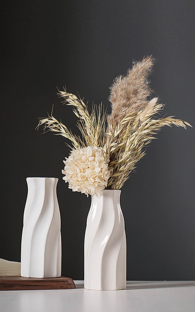 Stylish minimalist white vase decor featuring unique wave patterns and dried floral arrangement