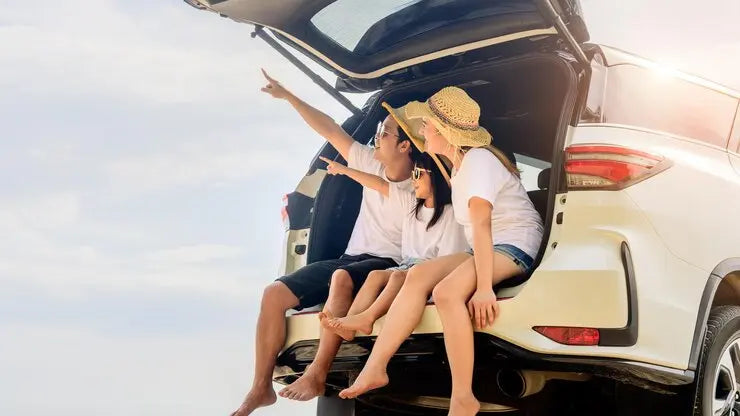 Family enjoying a road trip with car and travel essentials for a stylish and safe journey