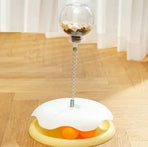 Leaky ball cat toy with a transparent top and spring base for interactive play and engagement